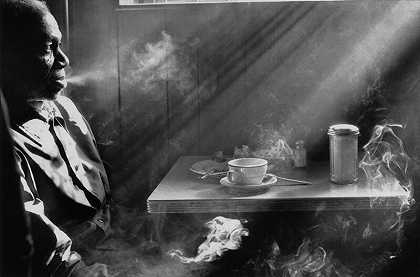 在餐厅吸烟的男人（纽约州纽约市）（1974年） by Harold Feinstein